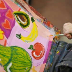a child is painting a picture on a canvas
